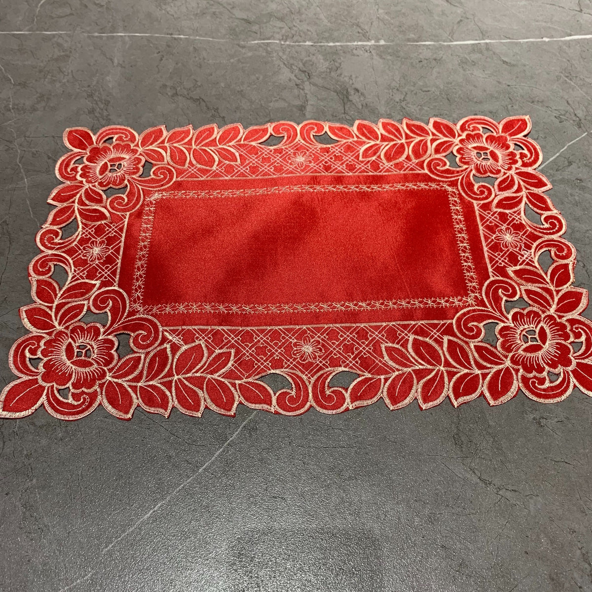 Embroidered cutwork placemat with floral border