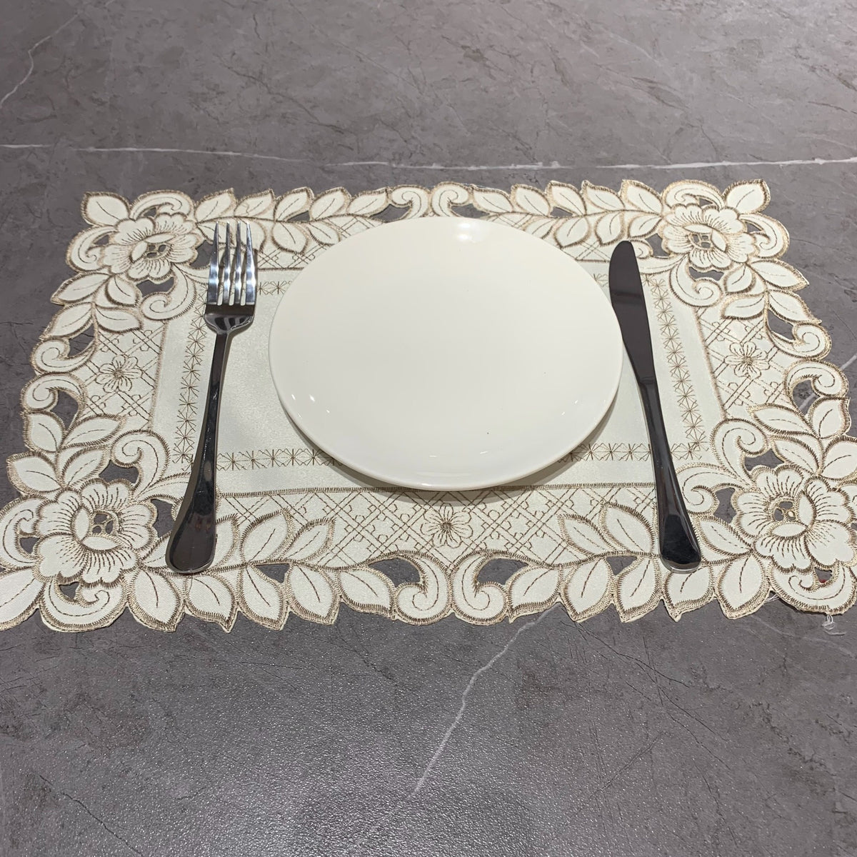 Embroidered cutwork placemat with floral border