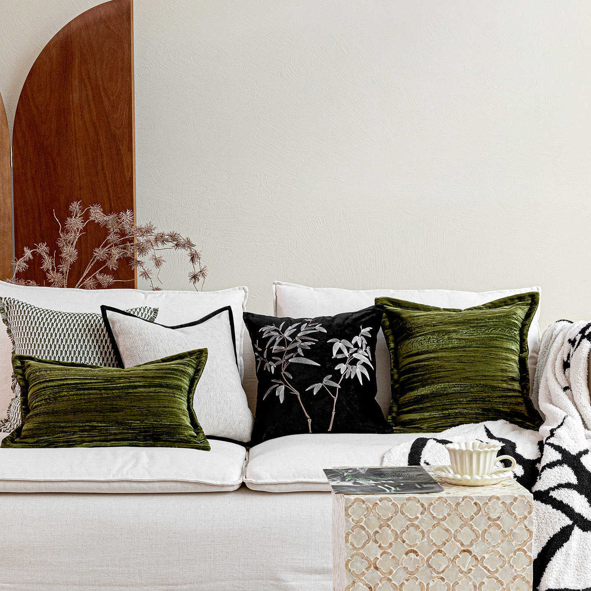 Vintage green cushion with embroidery-inspired motif